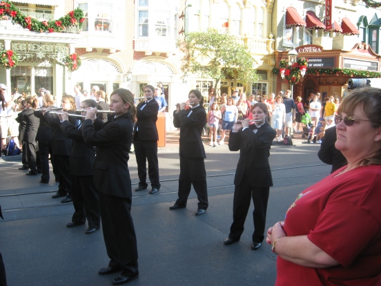 My daughter playing her piccolo while marching on Main Street USA again in 2007, back row last on right