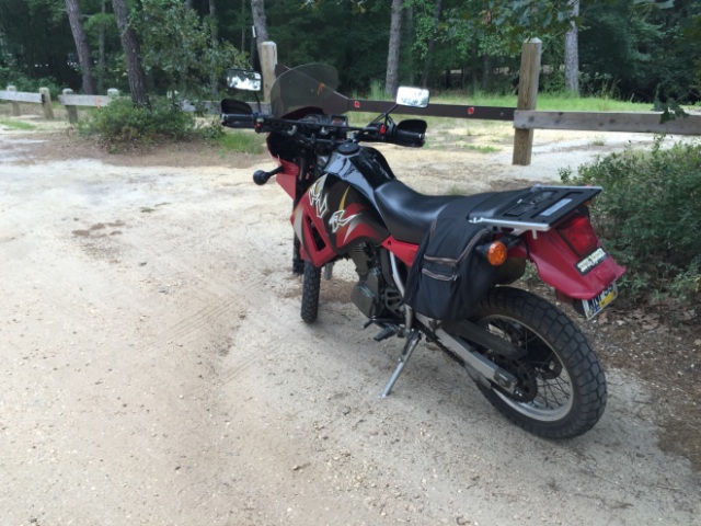 his bike is a Kawasaki KLR 650 - its street legal but also able to be taken off road.