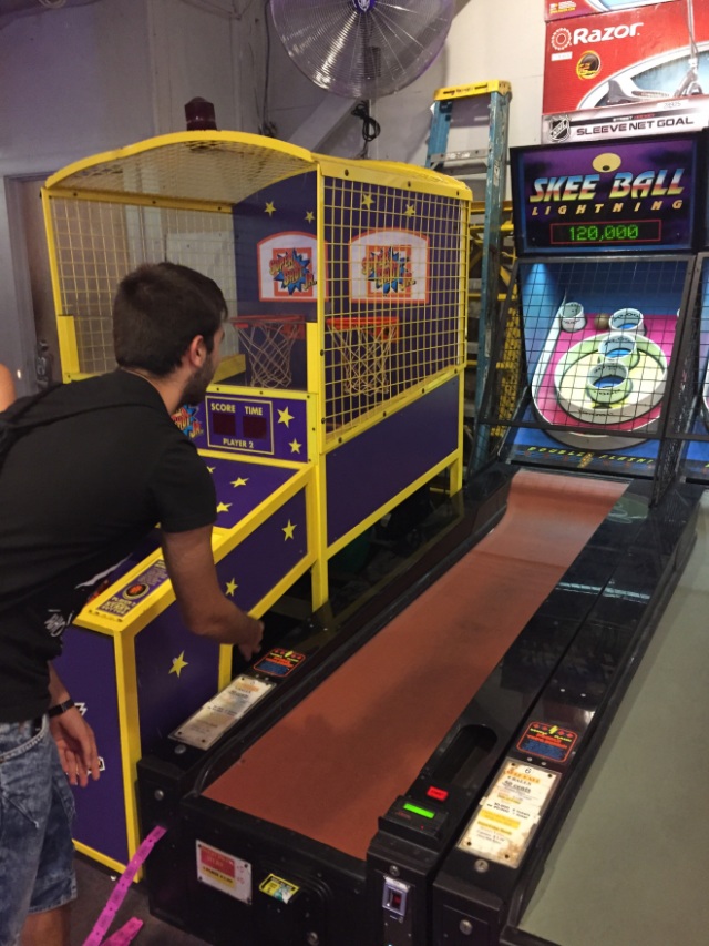 Alberto playing skee ball for the first time - I know - it doesn't say skee ball, but it's a version of it