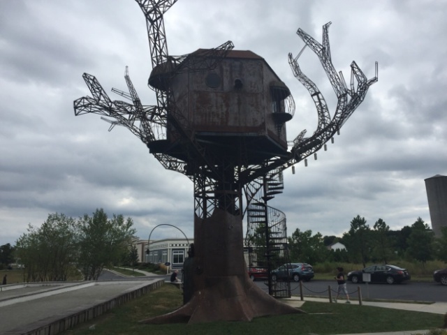 this is "Steampunk Tree House" is out front and was bought for $1 by Dogfish Head Brewery after it was done being used as an exhibit at "The Burning Man" in the Nevada desert in 2007